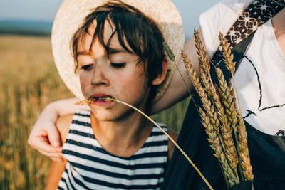 Close-up of boy eating crop at farm