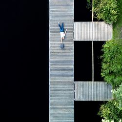 Woman walking along built structure