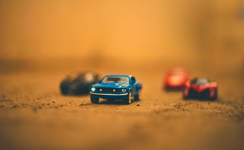 Close-up of toy cars on road