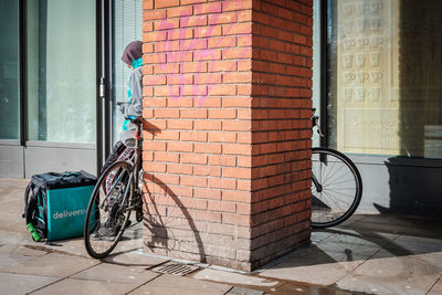 Bicycle on sidewalk against building