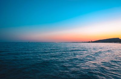 Scenic view of sea against clear sky at sunset