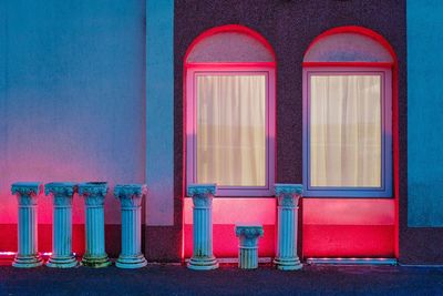 Neon illuminated windows of building