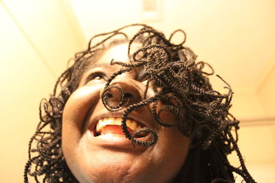 Low angle view of teenage girl with dreadlocks