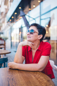 Portrait of an attractive mature woman wearing glasses in caffee person