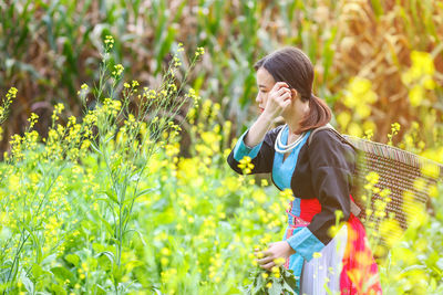 Side view of girl with basket in farm