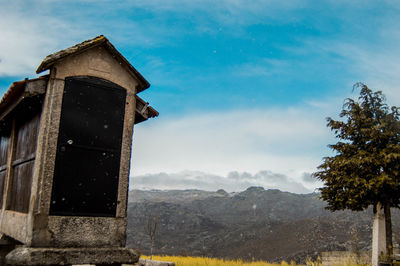 View of building and mountains against sky