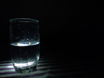 Close-up of drink in glass against black background