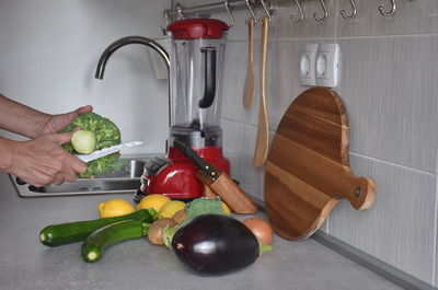 Midsection of woman preparing food in kitchen at home