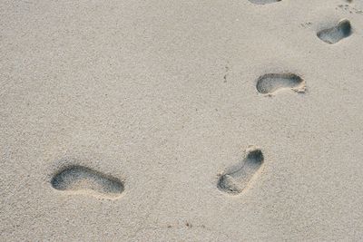 High angle view of footprints on sand