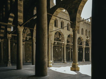 Low angle view of historical building showing arches and windows with mid day shadows