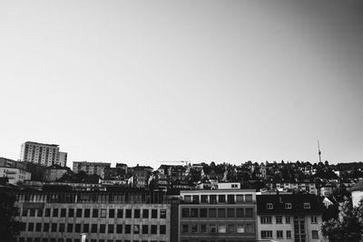 Buildings in city against clear sky