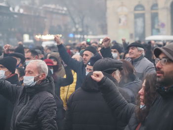 People standing on street in city during winter