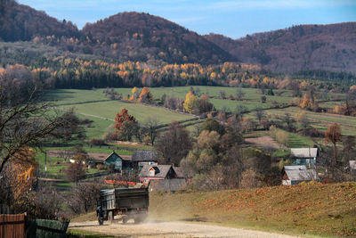 Houses on mountain against sky