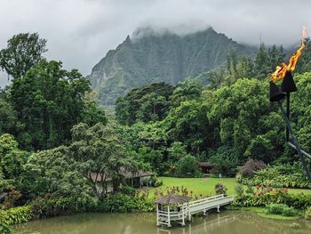 Scenic view of river amidst mountains against sky