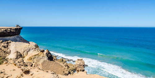 Scenic view of sea against clear blue sky