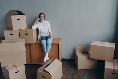 Portrait of young woman with cardboard box