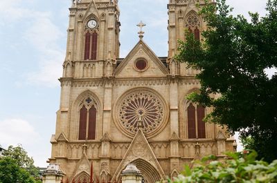 Low angle view of bell tower against sky