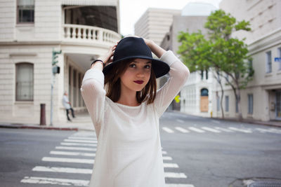 Young woman with hat on road