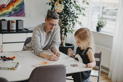 Woman with daughter at table