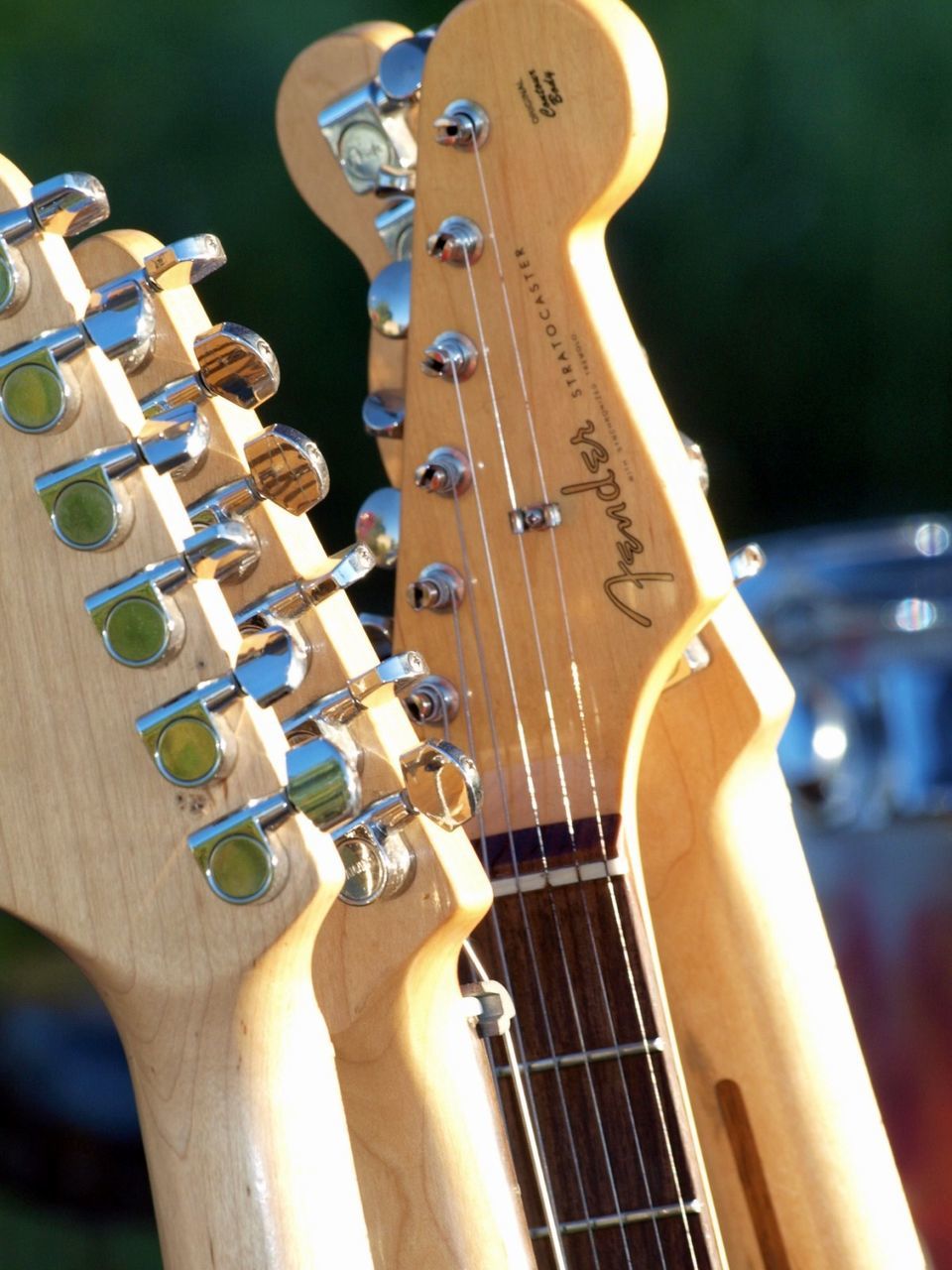 music, musical instrument, musical instrument string, arts culture and entertainment, string instrument, guitar, focus on foreground, close-up, wood - material, no people, playing, woodwind instrument, fretboard, electric guitar, outdoors, day, classical music