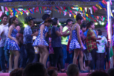 Group of people dancing in music concert