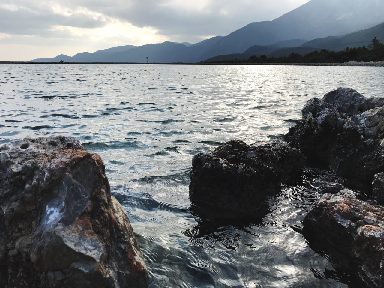 nature, water, beauty in nature, sea, tranquility, scenics, rock - object, mountain, tranquil scene, outdoors, no people, sky, day, sunset, wave