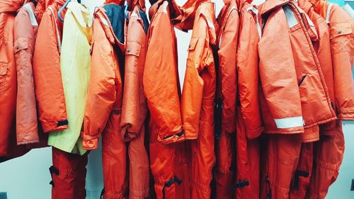 Red jackets hanging against wall