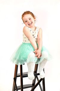 Portrait of young woman against white background