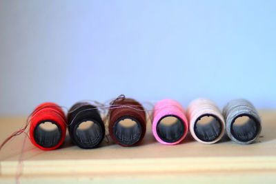 Close-up of multi colored pencils on table against blue background