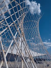 Low angle view of ferris wheel against blue sky