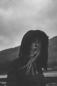 Portrait of woman standing against sky during winter