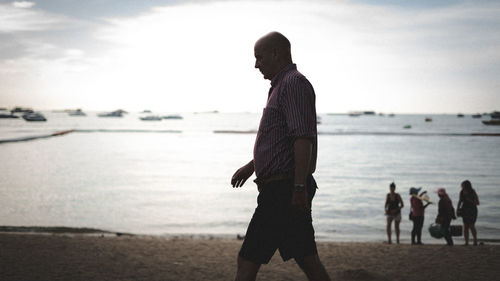 Man standing on beach against sea