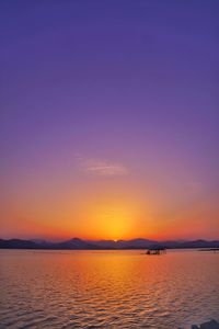 Scenic view of sea against romantic sky at sunset