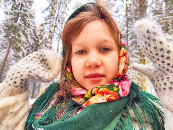 Portrait of young woman in warm clothing