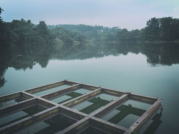 High angle view of swimming pool by lake against sky