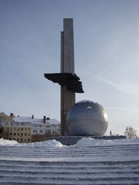 Tower on snow covered building against sky