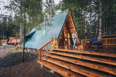 Girl on a deck of beautiful cabin in the woods