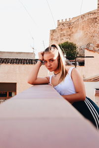 Portrait of beautiful woman sitting outdoors