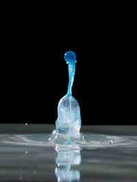 Close-up of water splashing over black background