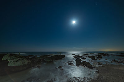 Scenic view of sea against sky at night