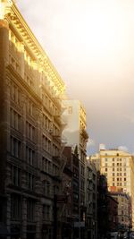 Low angle view of buildings against sky during sunset