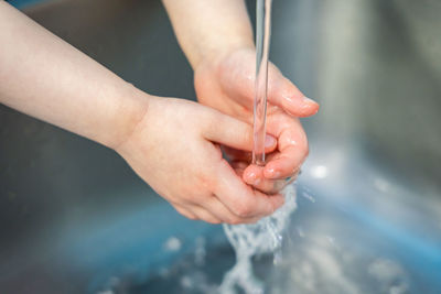 Close-up of hand holding water