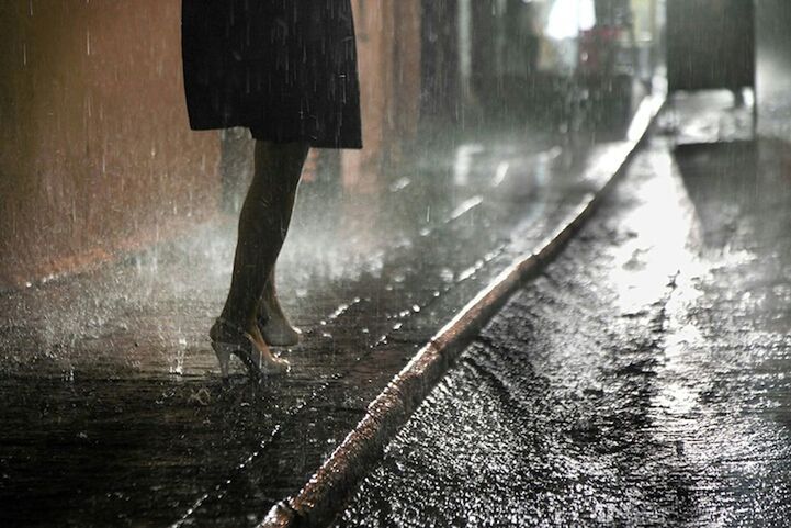 indoors, wet, rain, night, one person, wall - building feature, street, water, built structure, weather, season, motion, reflection, window, sunlight, puddle, shadow, architecture, falling, walking