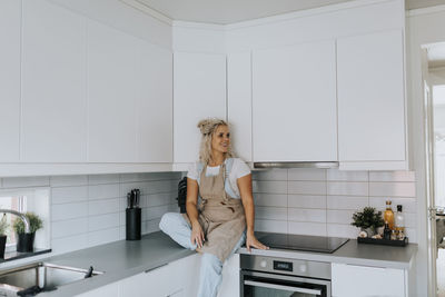 Woman sitting in kitchen