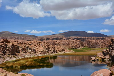 Scenic view of lake and mountains against sky