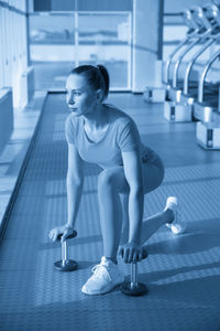 Full length of boy exercising in gym