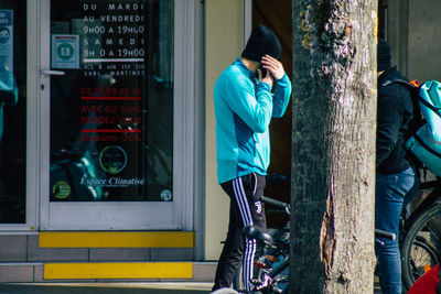 Man standing by window in city