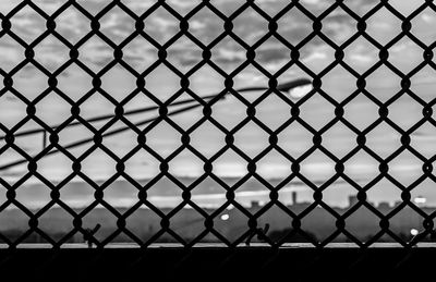 Chainlink fence against blurred background