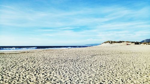 View of beach against cloudy sky