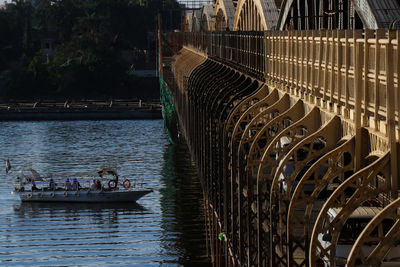 People in boat against river